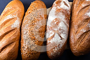 Many mixed breads and rolls shot from above. Top view of assortment of different cereal bakery