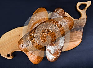 Many mixed breads and rolls shot from above. Top view of assortment of different cereal bakery