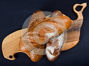 Many mixed breads and rolls shot from above. Top view of assortment of different cereal bakery