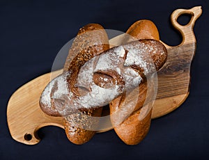 Many mixed breads and rolls shot from above. Top view of assortment of different cereal bakery