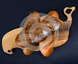 Many mixed breads and rolls shot from above. Top view of assortment of different cereal bakery