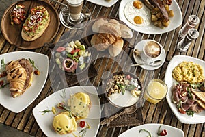 Many mixed western breakfast food items on cafe table