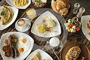 Many mixed western breakfast food items on cafe table