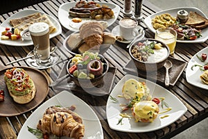 Many mixed western breakfast food items on cafe table