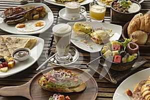 Many mixed western breakfast food items on cafe table