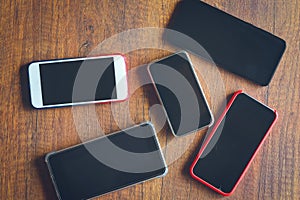 Many mobile phones on the wooden table