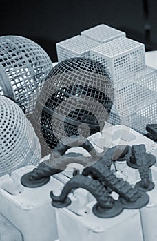 Many models printed on 3D printer. Gray and black objects printed 3D printer.