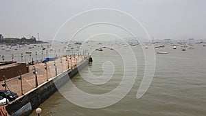 Many motor boats float in Mumbai sea near jetty photo