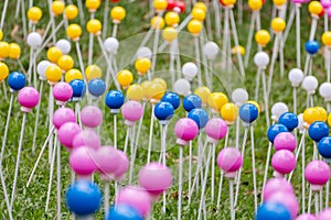 Many multi-colored plastic balls on legs