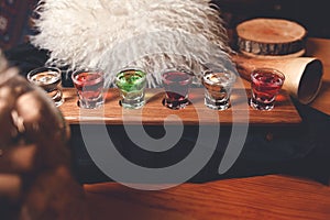 Many multicolored shot cocktails on the table in a Georgian restaurant. Homemade tinctures