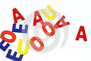 Multicolored vowels on white background