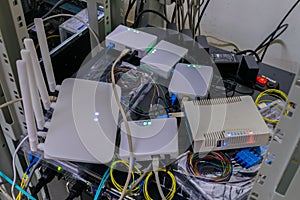 Many networked Internet devices are randomly placed in the rack. Subscriber terminals are tested in the server room of the data