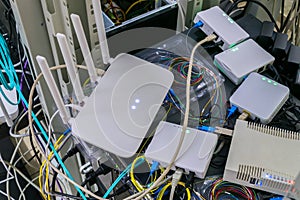Many networked Internet devices are randomly placed in the rack. Subscriber terminals are tested in the server room of the data