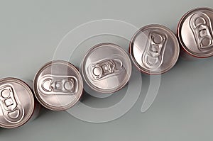 Many new aluminium cans of soda soft drink or energy drink containers. Drinks manufacturing concept and mass production