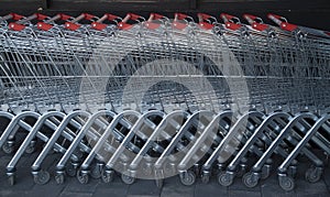 Many new metal shopping carts in line outside
