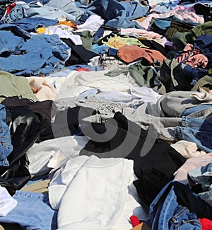 many new and used clothes for sale in the flea market without pe