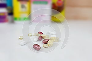 Many nutritional health supplements and vitamins in capsules, tablets and in bottles on a white background