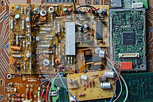 Many old printed circuit board with radio components on background. Vintage circuit boards with soldering trace, parts and