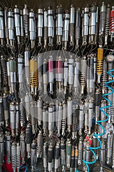 Many old shock absorbers hanging at a repair shop on Hanoi street, Vietnam