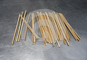 Many old traditional chopsticks put on metal table to desiccation photo