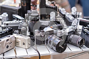 Many Old Vintage Soviet Analog Photo Camera on a Flea Market Outdoors.