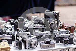 Many Old Vintage Soviet Analog Photo Camera on a Flea Market Outdoors.