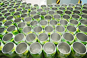 Many open aluminum cans for drinks move on conveyor