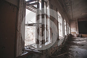 Many open windows in an abandoned rural school near the city of Pripyat, Chernobyl region, exclusion zone, Ukraine