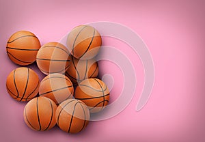 Many orange basketball balls on pink background. Space for text