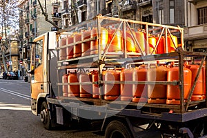 Many orange gas cylinders transported in car