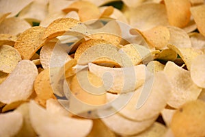 Many orange Pringles potato snack chips. Pringles is a brand of potato snack chips owned by Kellogg Company