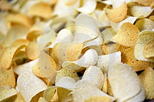 Many orange Pringles potato snack chips. Pringles is a brand of potato snack chips owned by Kellogg Company