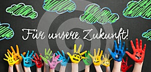Many painted kids hands with smileys and the message `For our feature!` in German