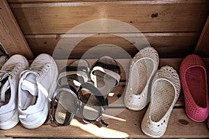 Many pairs of summer shoes needs to be cleaned and organized for storage, out of season shoes