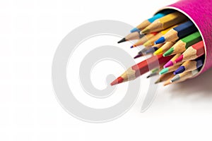 Many pencil colors in box isolated on white paper background.Red pencil offside each other.Leader business concept.