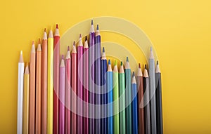 Many pencils of different colors in a row