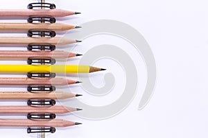 Many pencils are placed orderly shaft on the paper notebook.