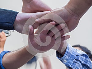 Many people hands in a circle together. Low angle of view. Concept of teamwork and unity