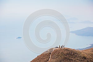 Many people hiking on the path to the famos location, Sunset Peak, Lantau Island, Hong Kong