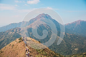 Many people hiking on the path to the famos location, Sunset Peak, Lantau Island, Hong Kong