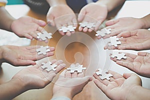 Many persons holding pieces of jigsaw puzzle,Teamwork concept,,Business connection,Success and strategy concept,Business accountin