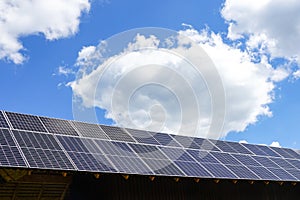 Many photovoltaic solar panels mounted on wooden house roof, roof of solar cells