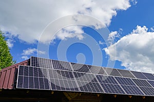 Many photovoltaic solar panels mounted on wooden house roof, roof of solar cells