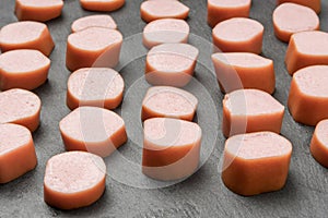 Many pieces of fresh pork sausages of different sizes are cut for frying and adding to soup. Semimanufactures. creative background