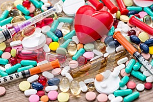 Many pills , syringes , ampoules and heart