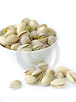 Many pistachio on white background photo