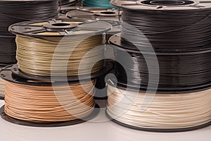 Many PLA and ABS filament spools for 3D printer. photo