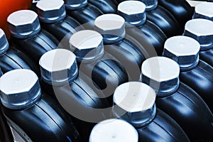 Many plastic canisters with engine oil. Container for bottling of petroleum products