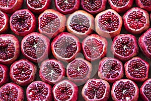 Many pomegranate cut in half, pomegranate background. Selective focus