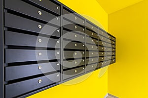 Many post boxes in modern apartment building. Postage boxes in an apartment complex